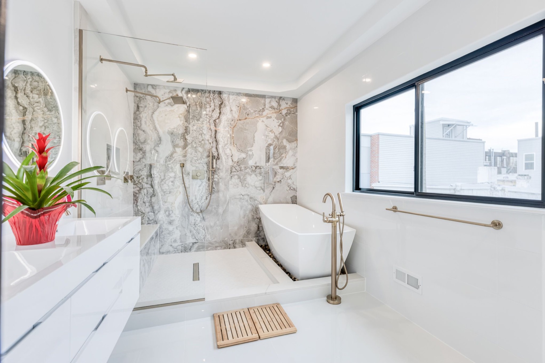 Custom bathroom with freestanding tub and marble tile remodeled by Paiz Builders in Philadelphia