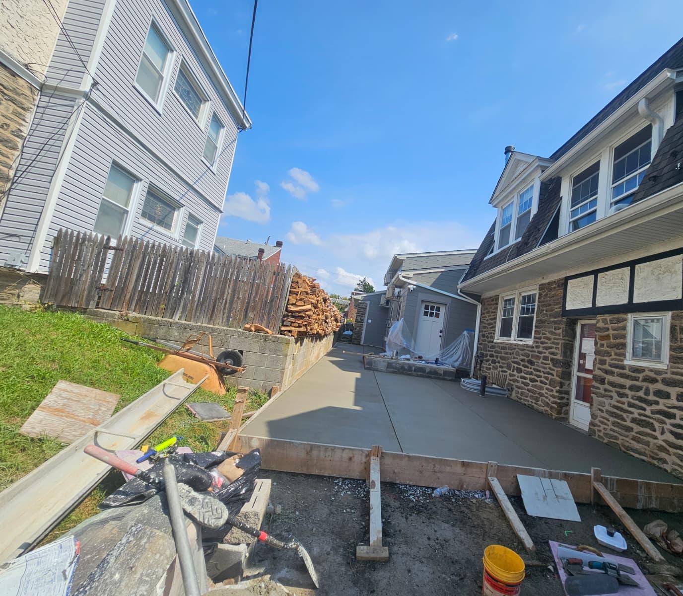 Wide view of the finished concrete pad with the edge forms still in place