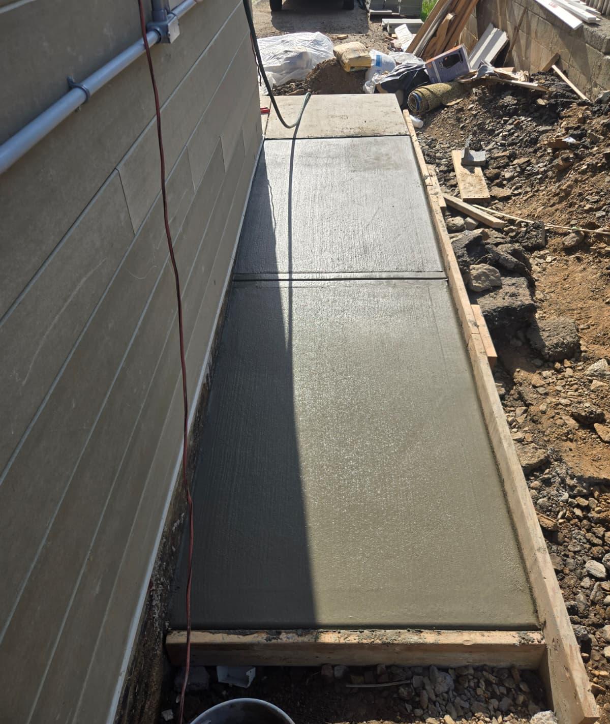 First section of the side walkway poured along the house with forms in place