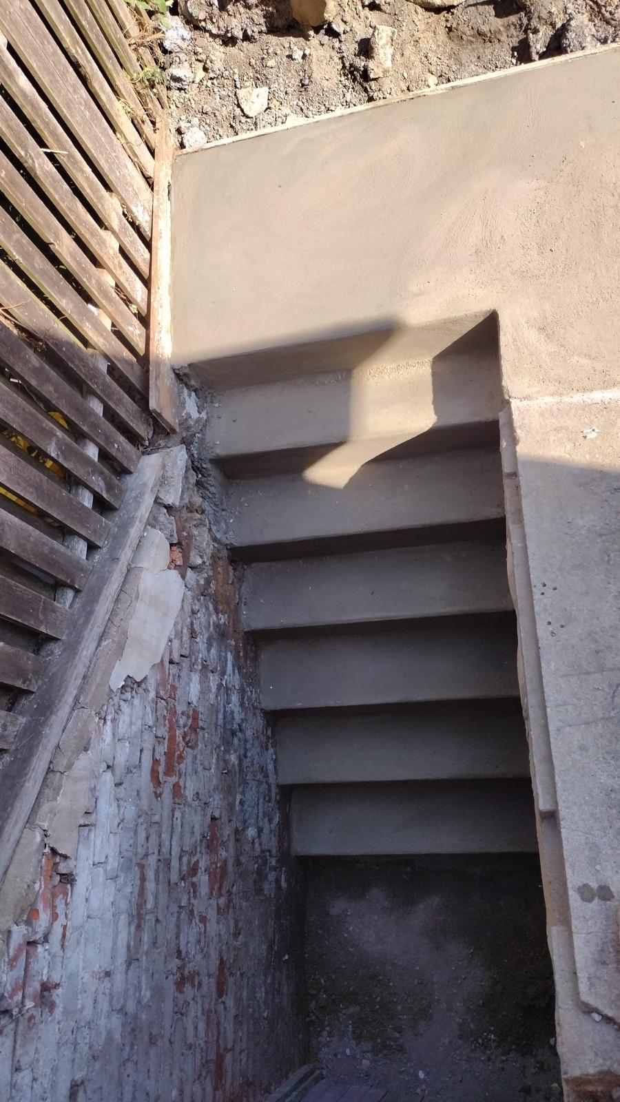 Poured concrete basement steps and sidewalls seen from above