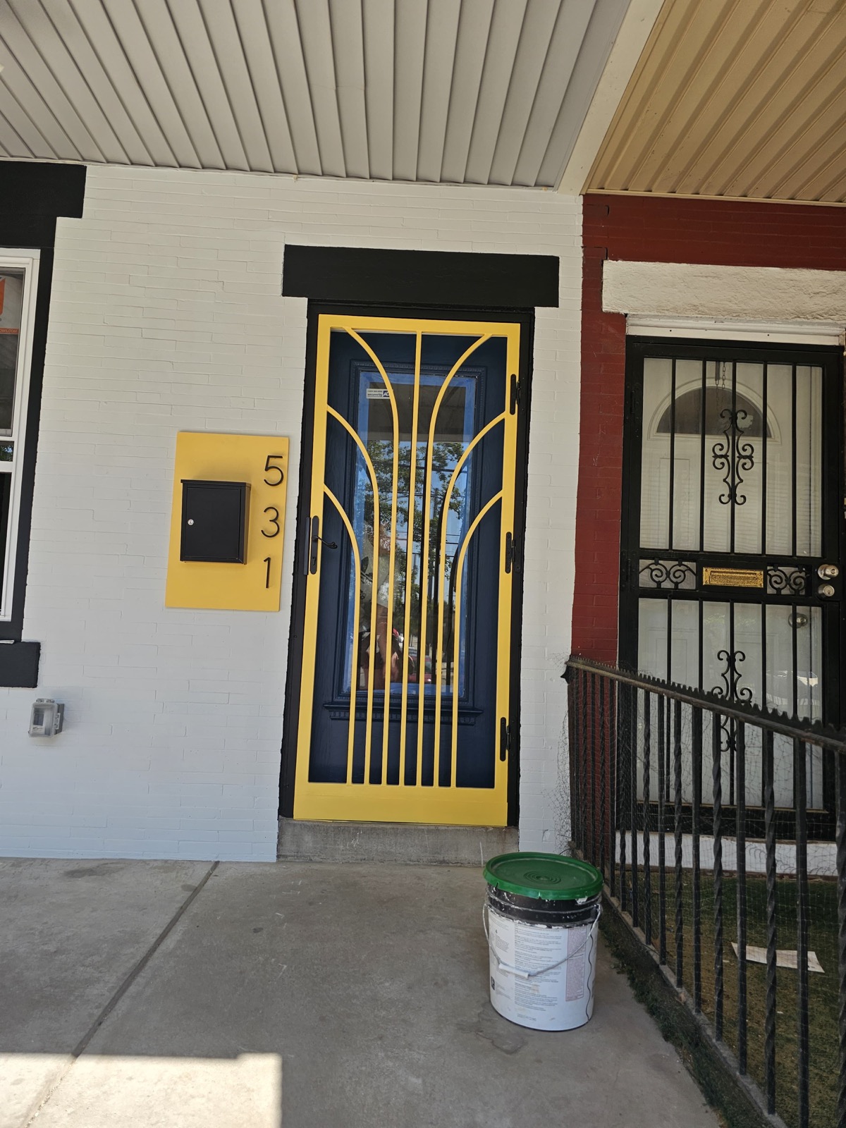 Custom yellow art-deco security door and mailbox panel