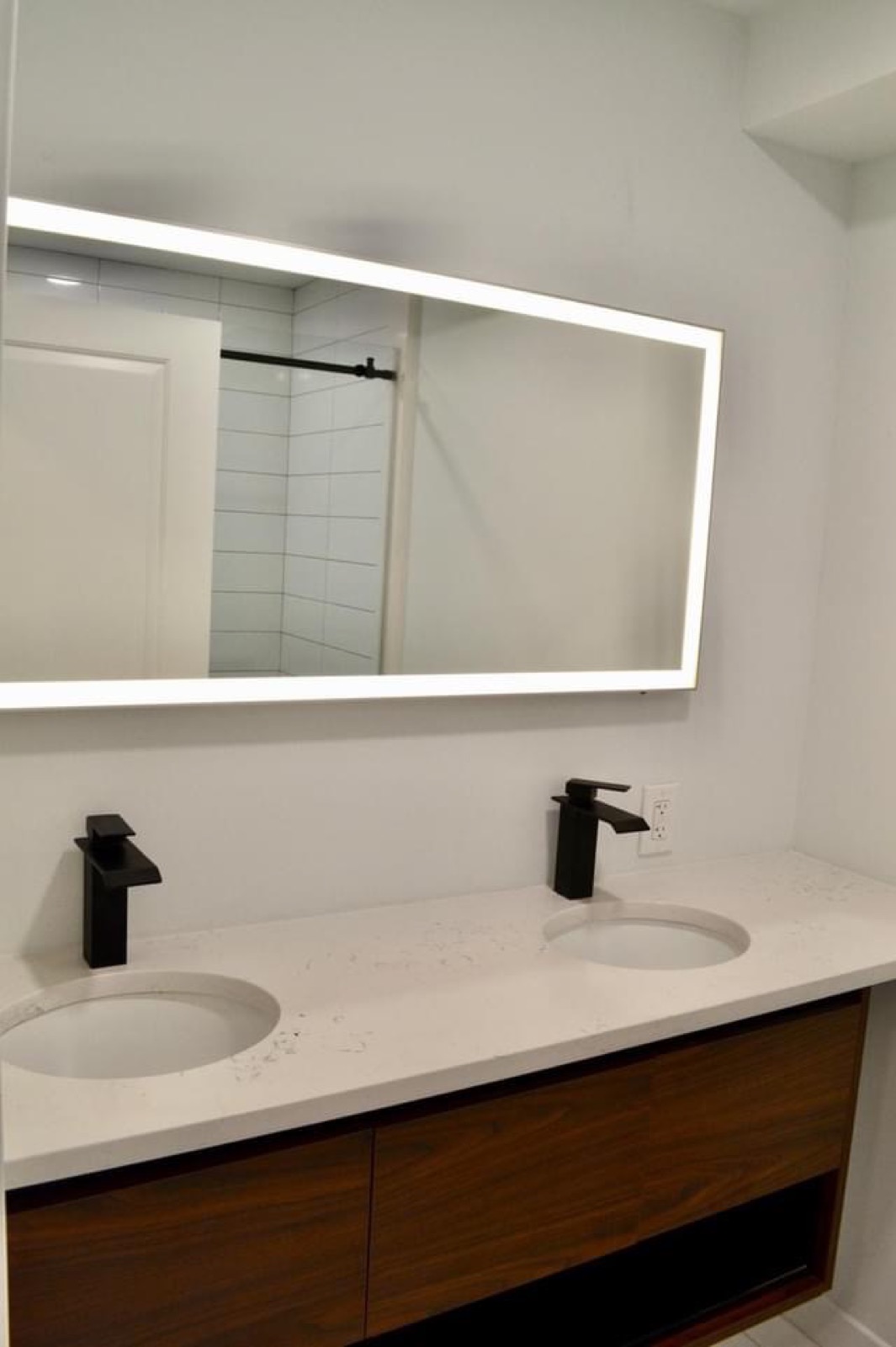 Walnut double vanity with backlit mirror in Kensington