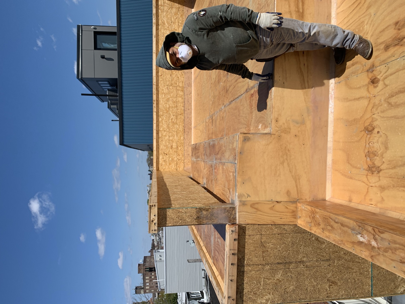 Roof deck sheathing and parapet framing over city rooftops