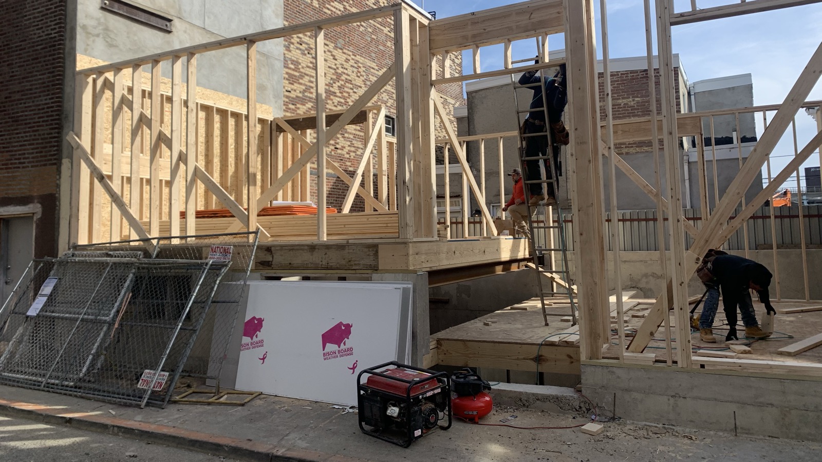 Crew framing wood stud walls on an addition