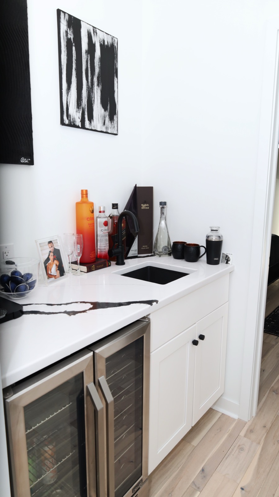 Custom wet bar with quartz counter and dual-zone wine fridge