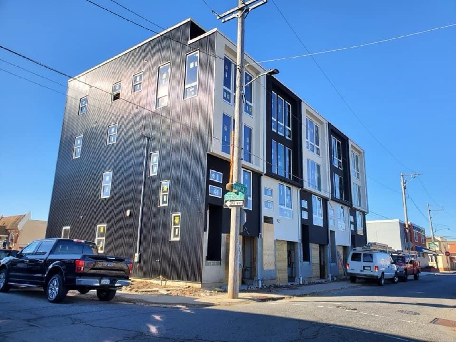 Black corrugated metal multifamily building at the street corner