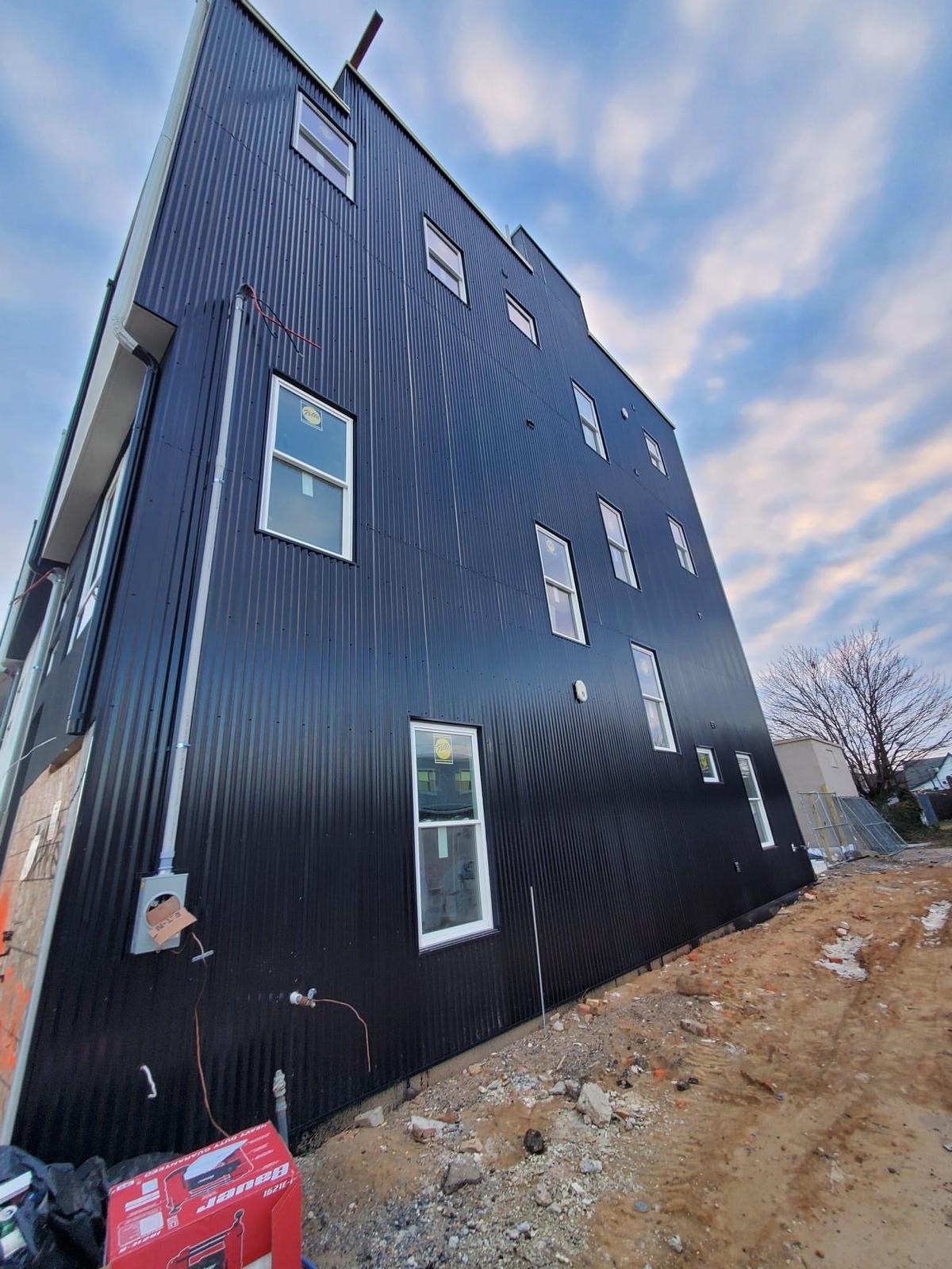 Black corrugated siding at dusk