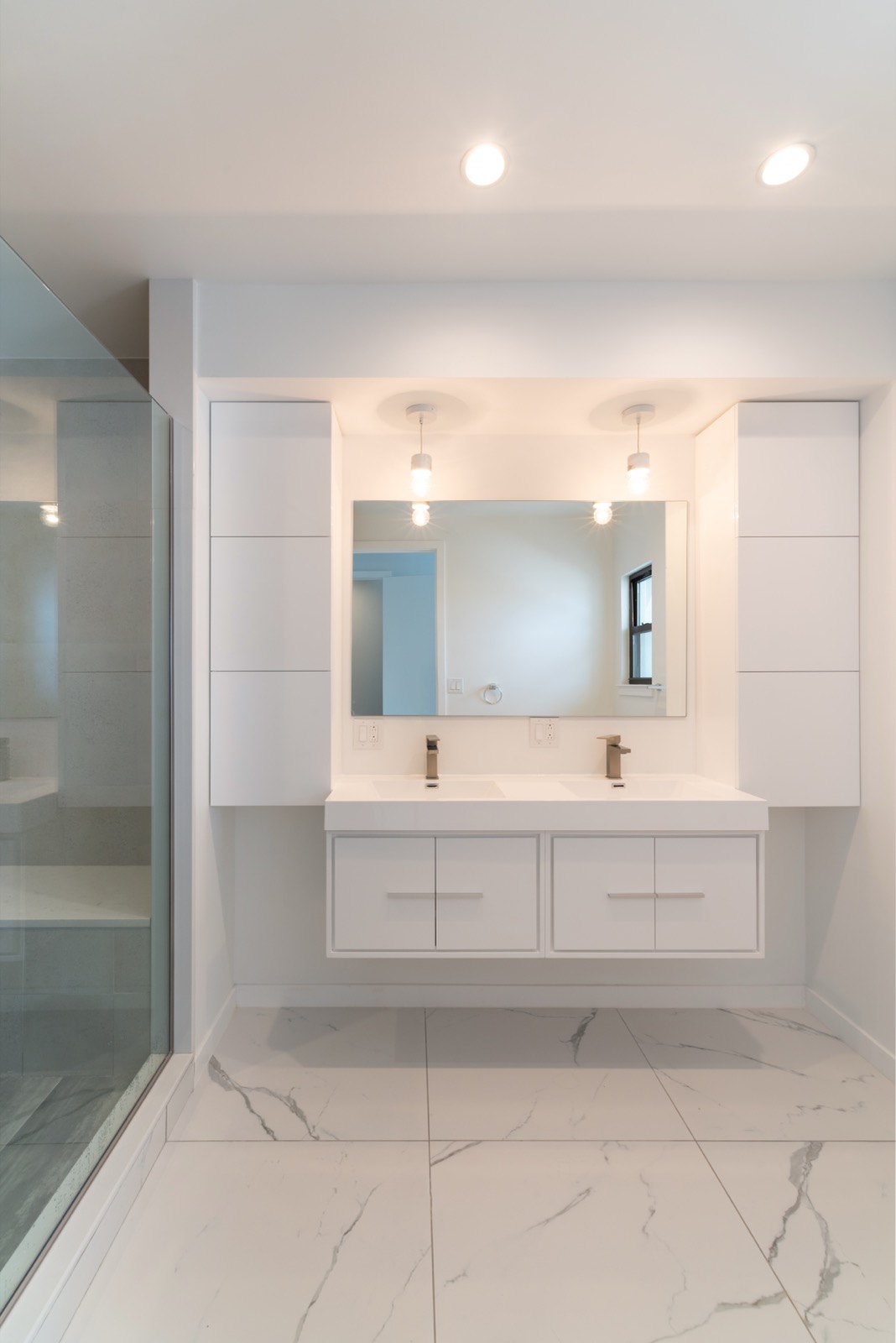 Floating double vanity bathroom with marble floor in Port Richmond