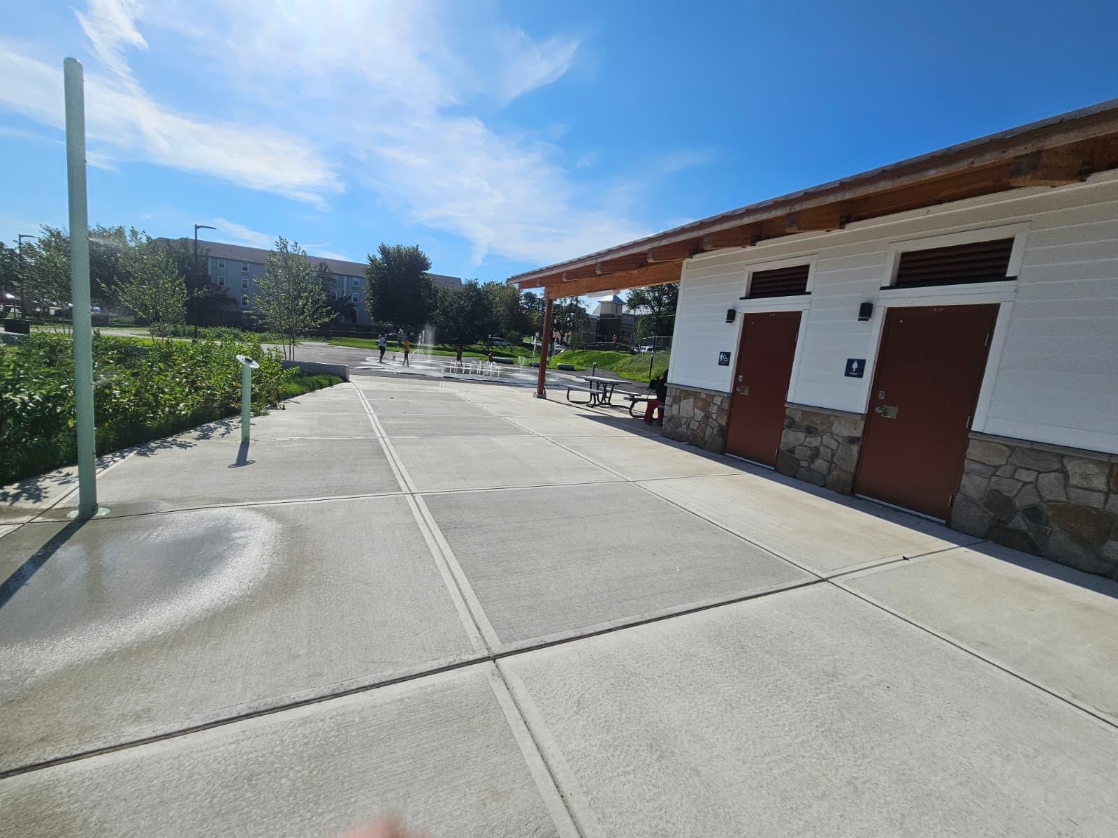 Concrete plaza paving outside the restroom building entries
