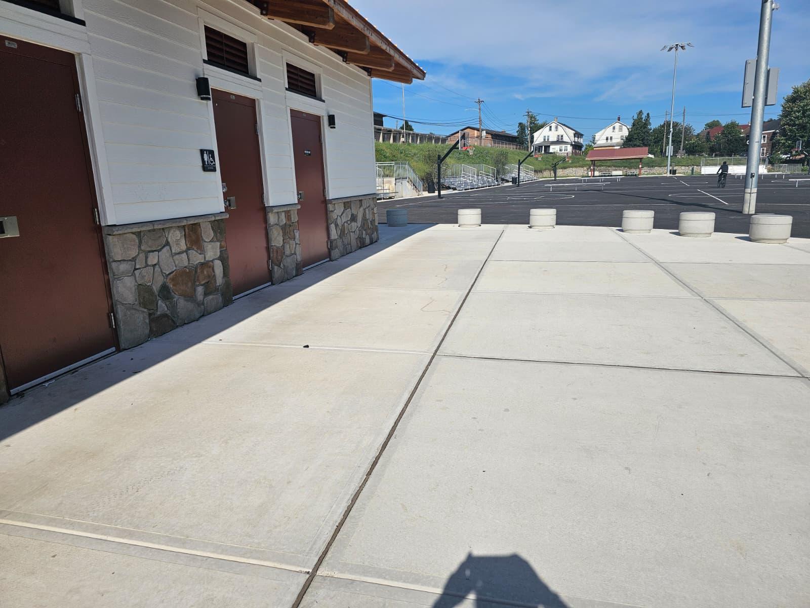 Wide concrete walkway along the building entrances