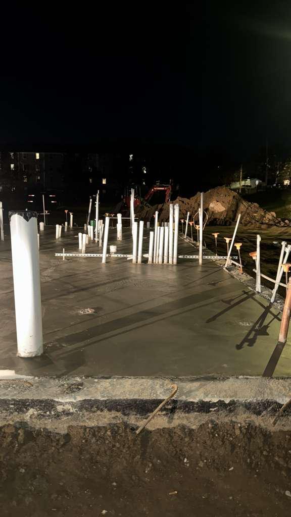 Building slab poured and finished under lights at night