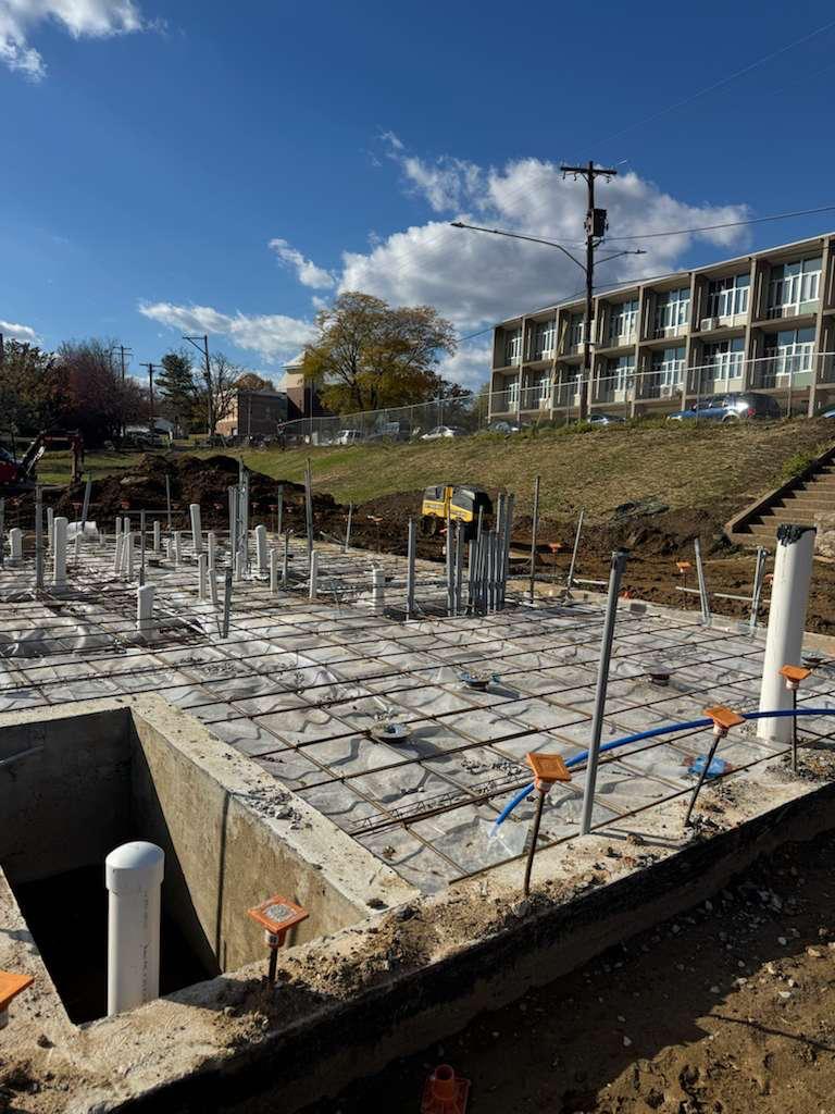 Slab prep with vapor barrier, wire mesh, and plumbing stub-ups before the pour