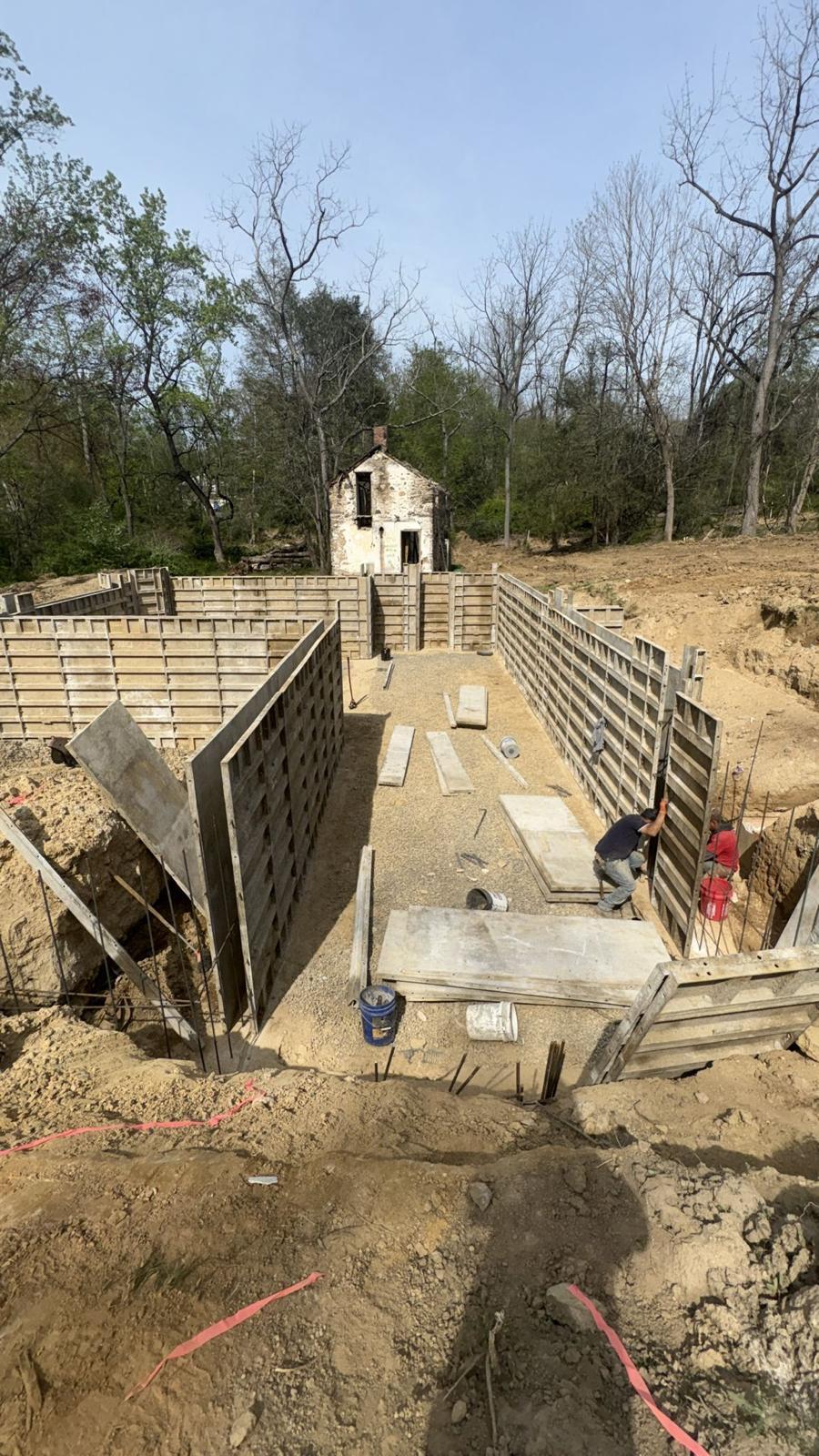 Wall forms set on the footings for a poured concrete foundation