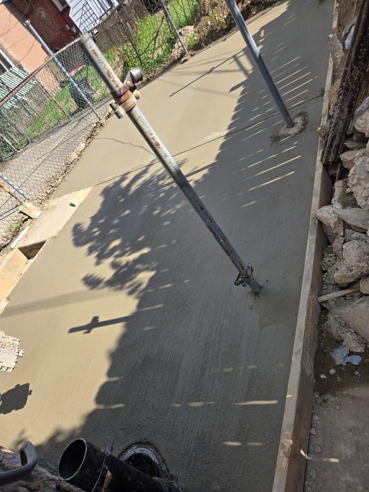 New concrete pad poured around temporary steel shoring posts