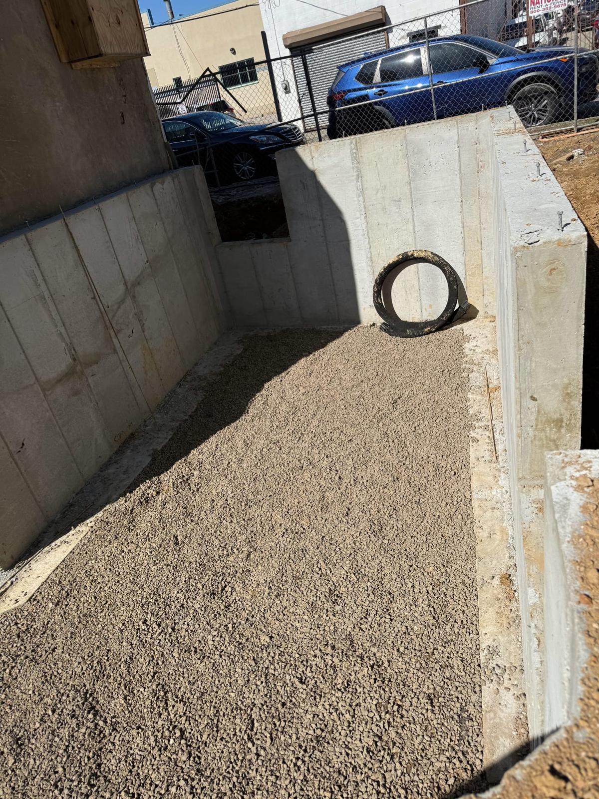 Poured concrete retaining walls with clean stone backfill