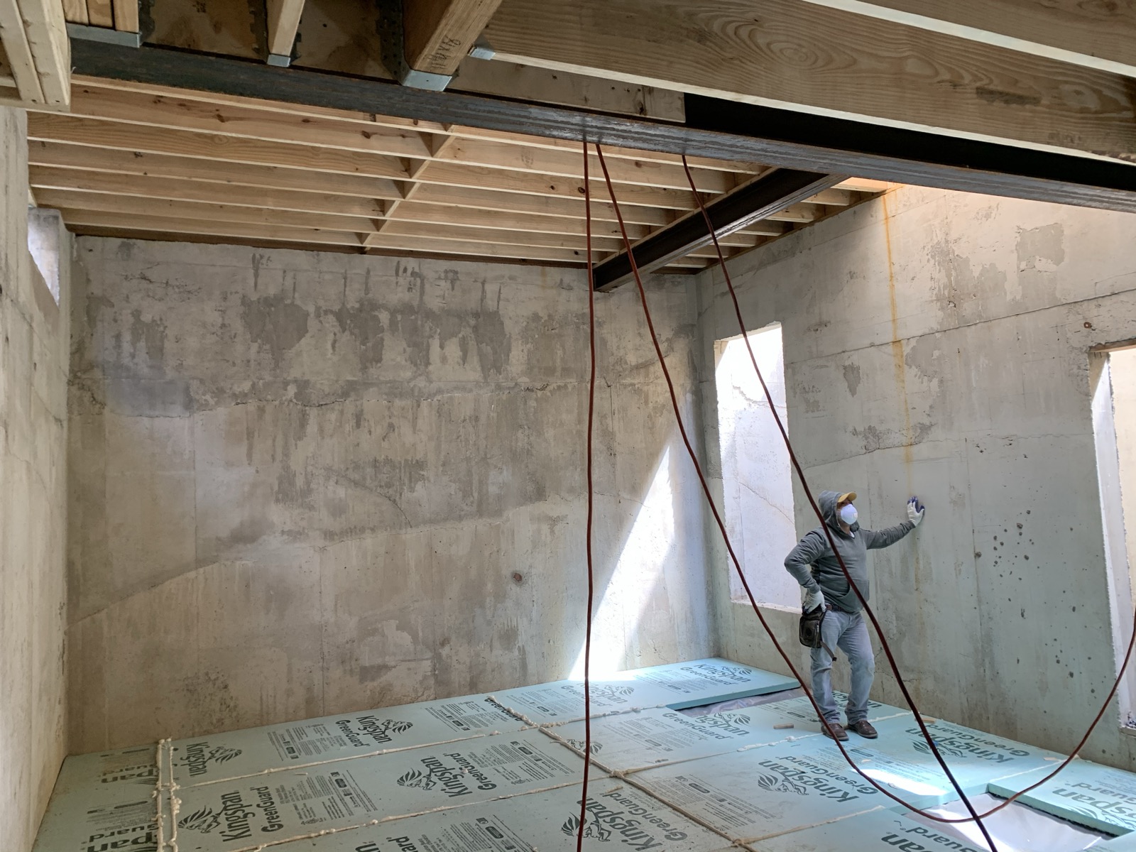 Basement with poured concrete walls and steel beam