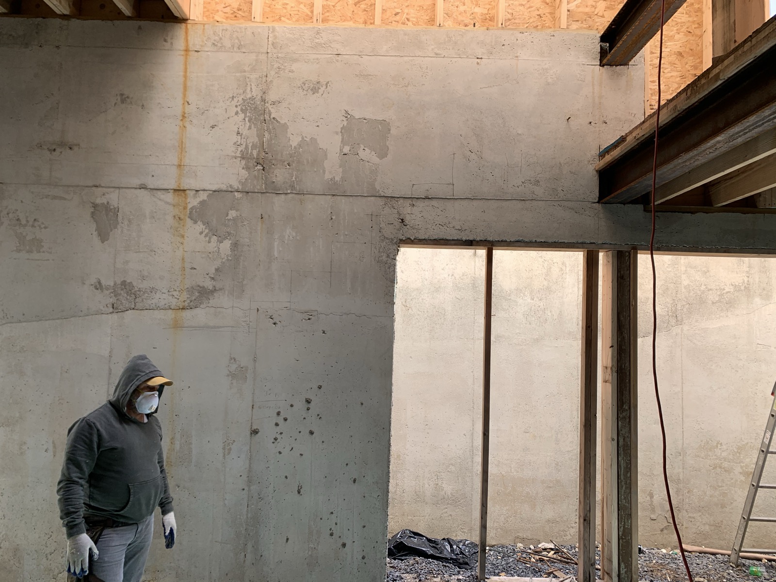 Poured concrete party walls with steel beams and framing above