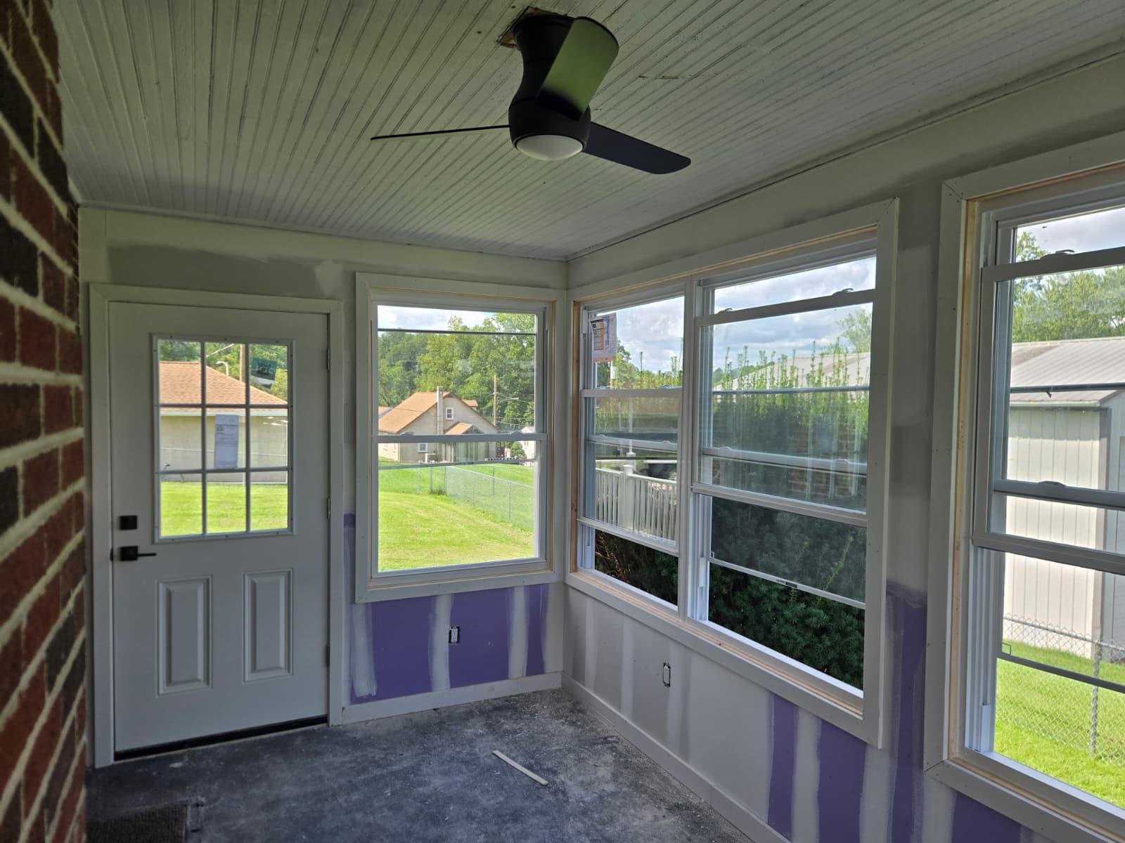 In progress: new windows and entry door set in the enclosed porch
