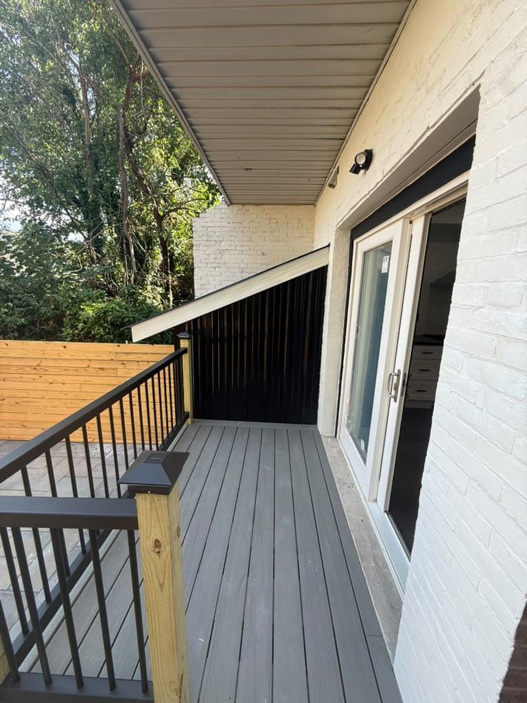 Composite deck with black railing outside the sliding glass doors